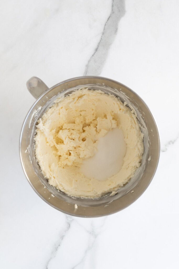 Sugar added to cream cheese in a stand mixer