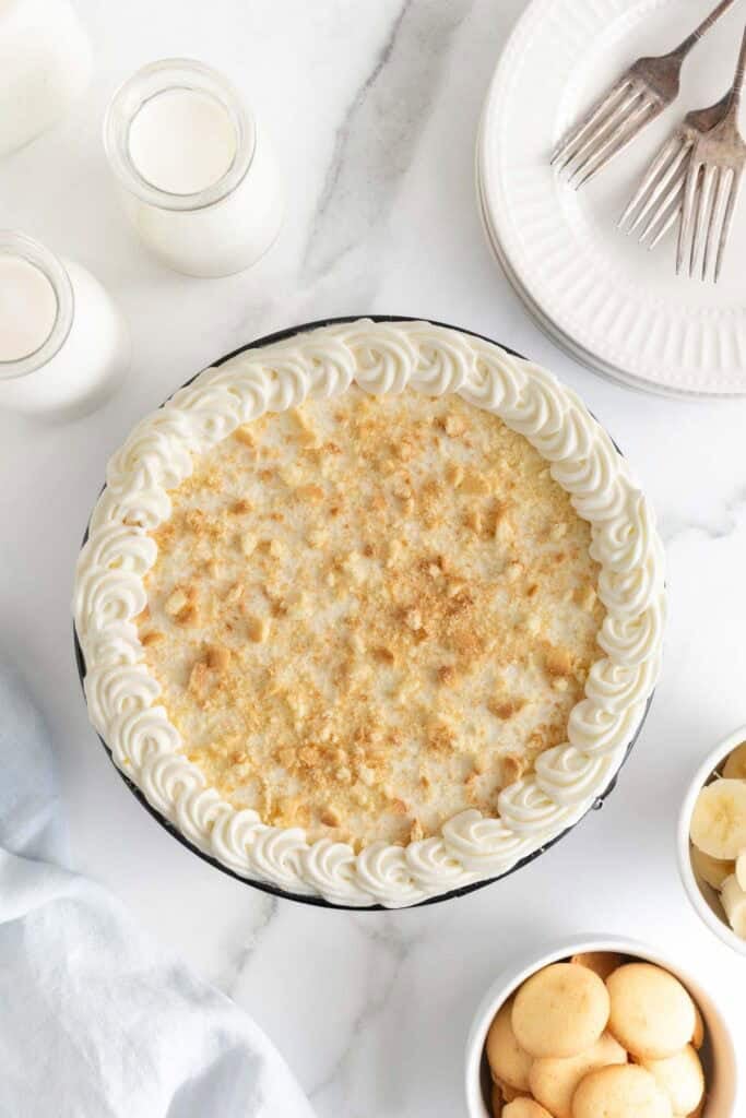 Banana pudding cheesecake recipe on white countertop with nilla wafers