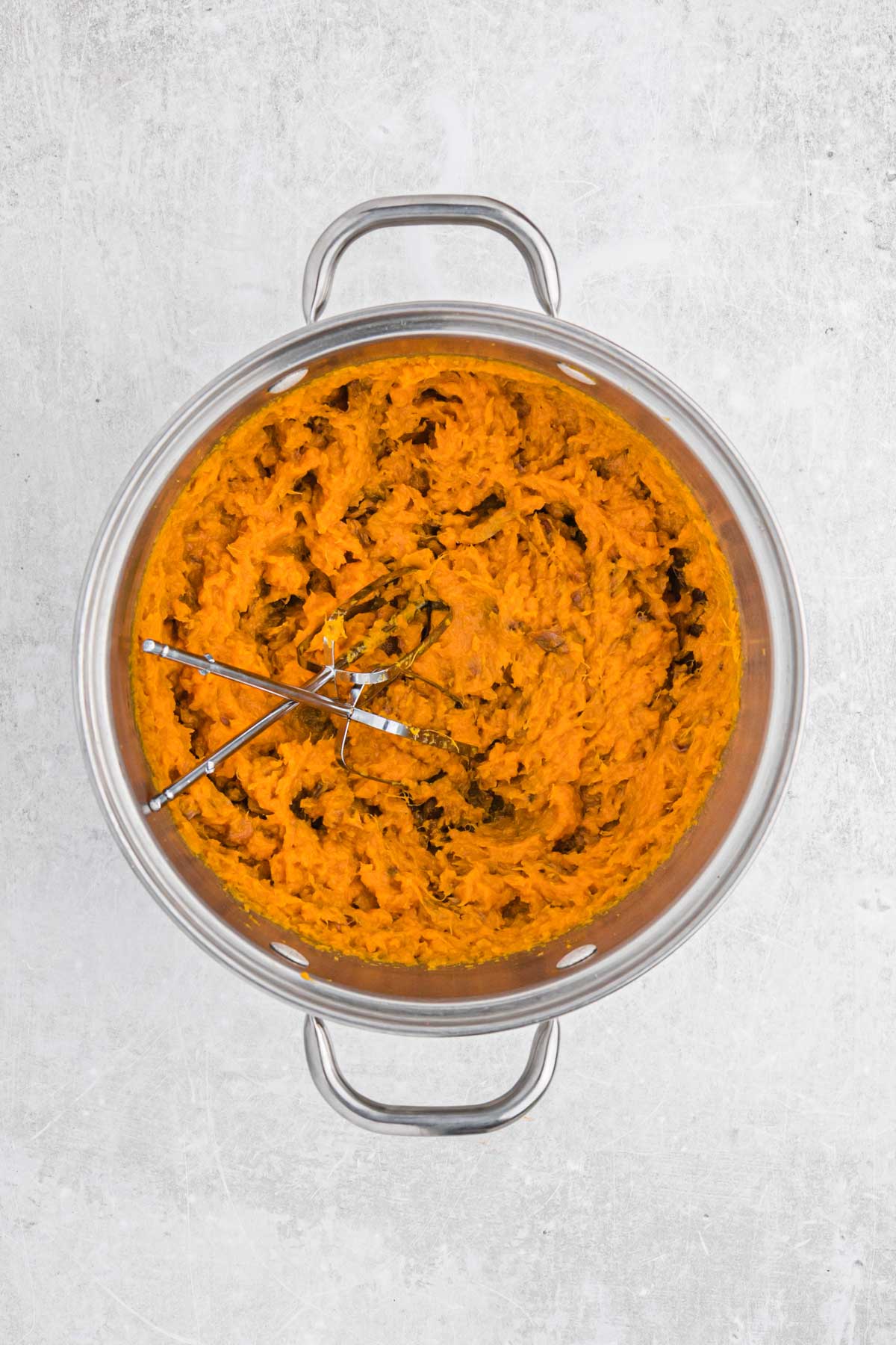 Mashed sweet potatoes in a pot.