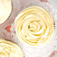 A close up of frosting piped on cupcake like a rose