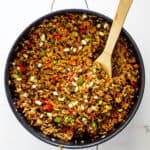 A large pot of dirty rice recipe after just being cooked ready to serve on plates