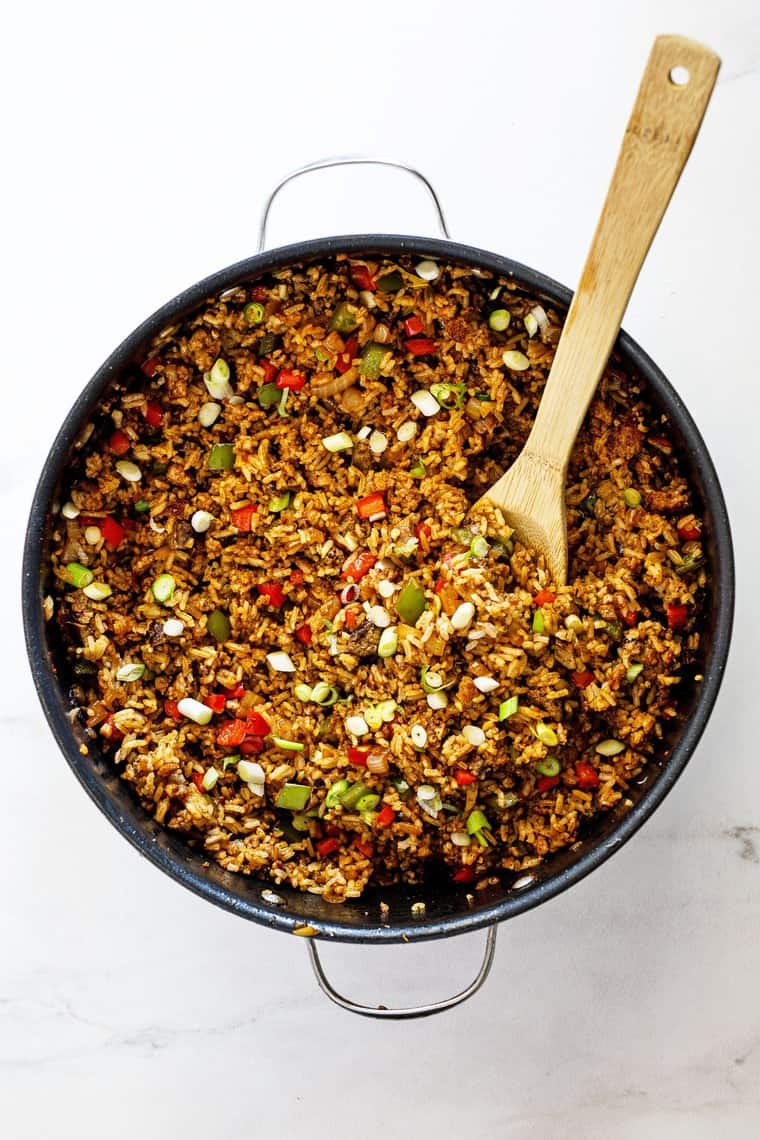 A large pot of dirty rice recipe after just being cooked ready to serve on plates