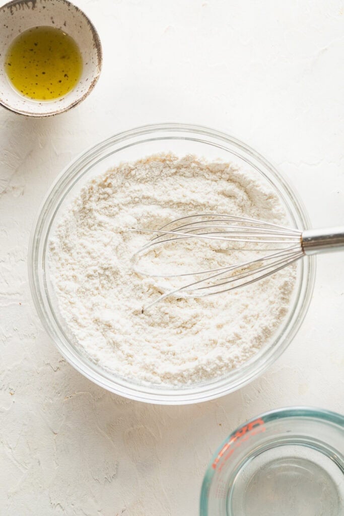 Flour and yeast whisked together in a large bowl