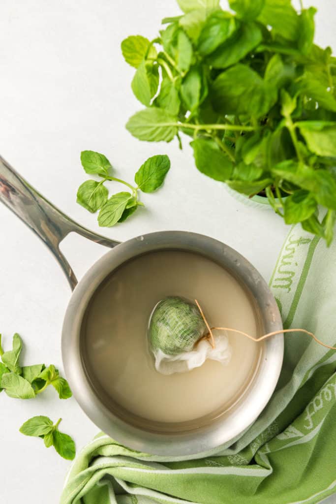 Mint simple syrup being prepared for drinks