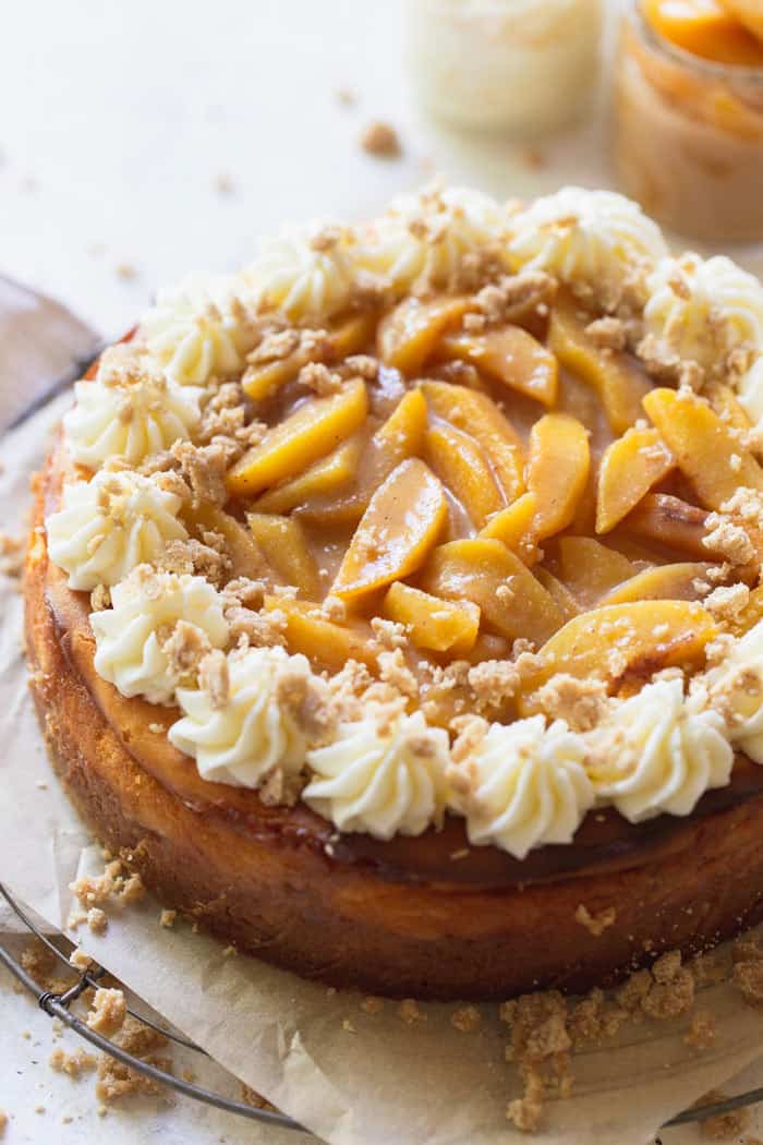 A close up of peach cobbler cheesecake before slicing for dessert