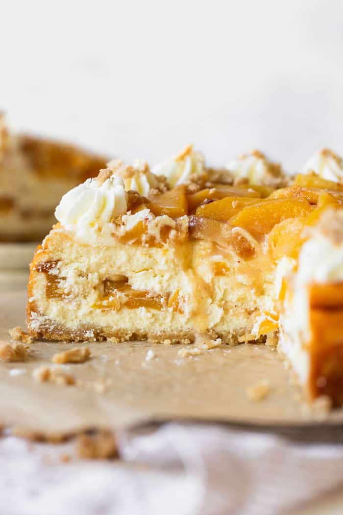 A close up of inside of Peach cheesecake with peach filling