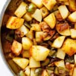 Southern smothered potatoes with green peppers and onions ready to serve with dinner