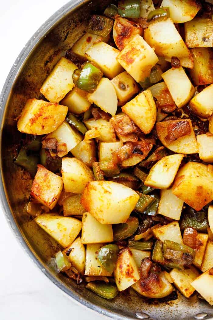 Southern smothered potatoes with green peppers and onions ready to serve with dinner