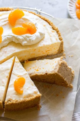 No Bake Orange cheesecake with three slices cut and one leaning on its side