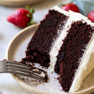 Dark chocolate cake being eaten with a fork