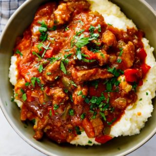 Cajun grillades and grits in a large bowl ready to serve