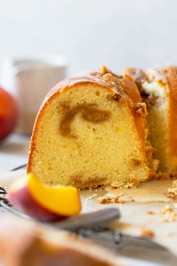 A close up of peach jam filling in peach pound cake ready to enjoy