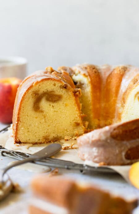 Bundt cake sliced open with peach swirl in the center
