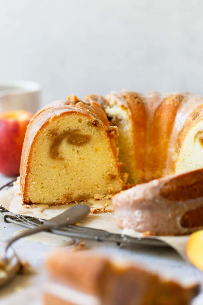 Bundt cake sliced open with peach swirl in the center