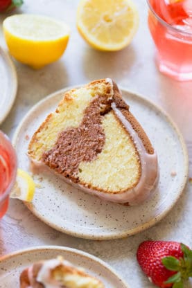 A close up of a lemon cake with strawberry swirl in the center