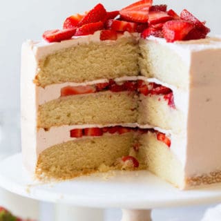 A close up of sliced strawberry shortcake cake ready to serve