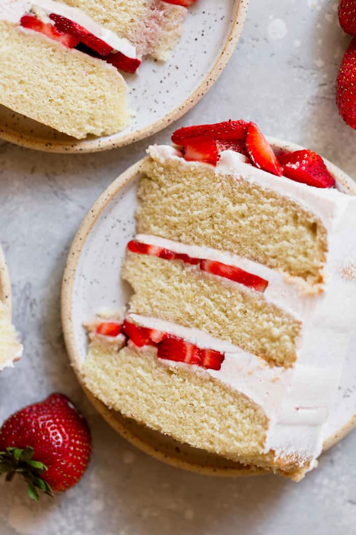 Slices of vanilla cake with strawberry and buttercream filling