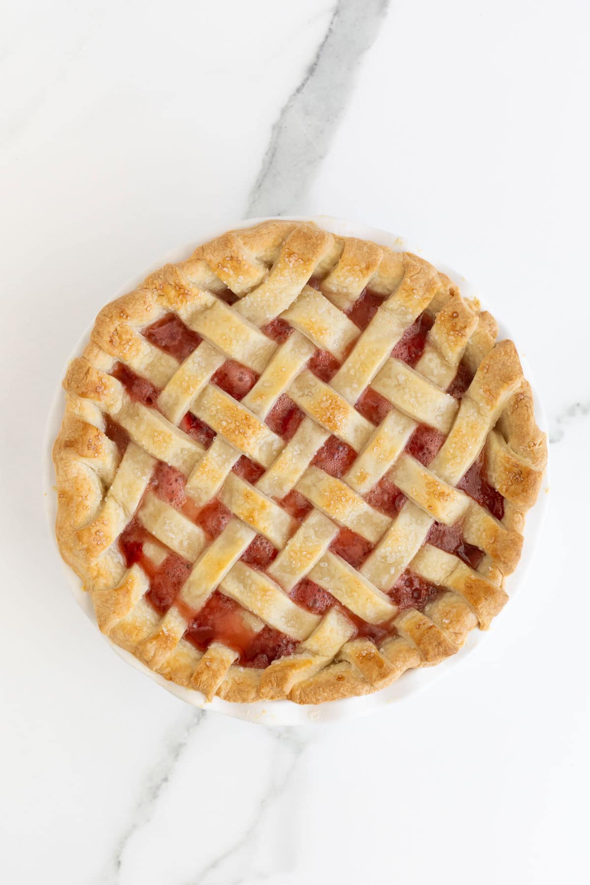 Freshly baked strawberry pie with golden lattice crust
