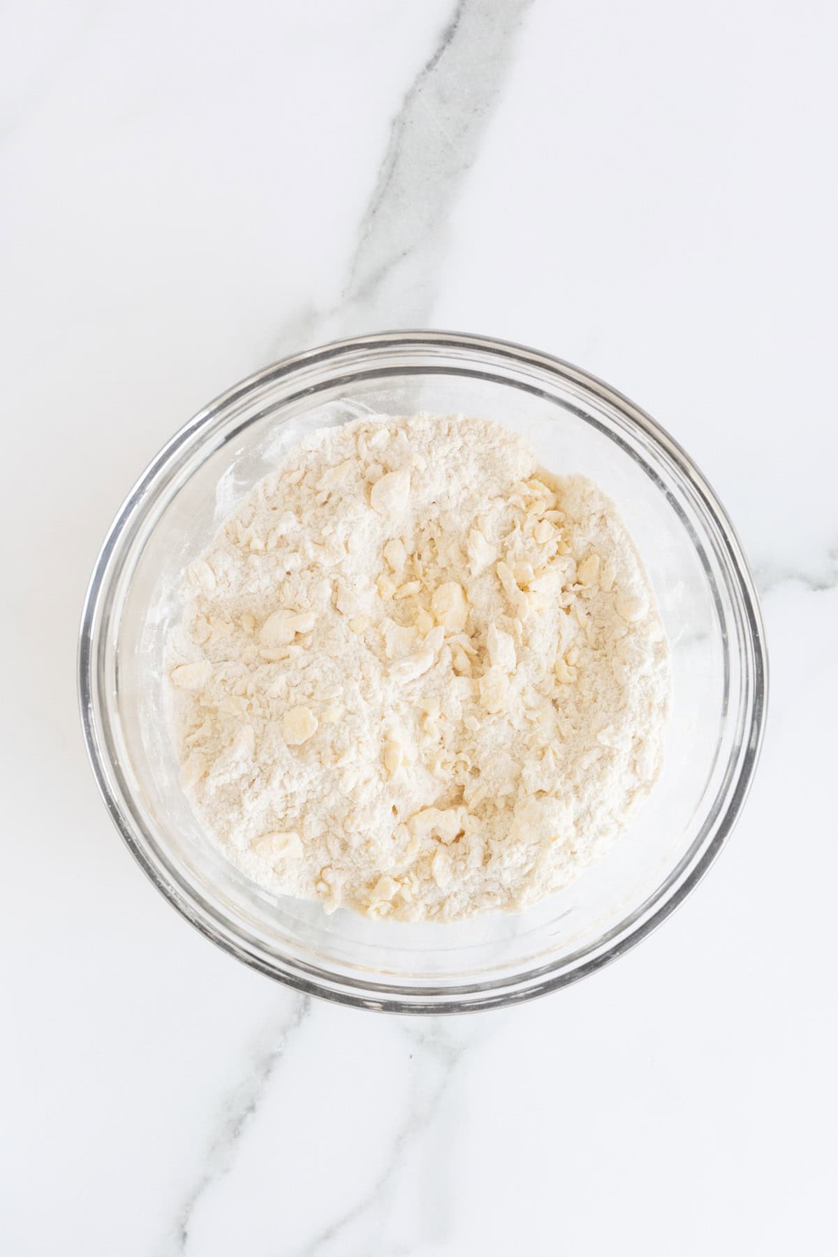 Butter cut into flour until crumbly texture forms