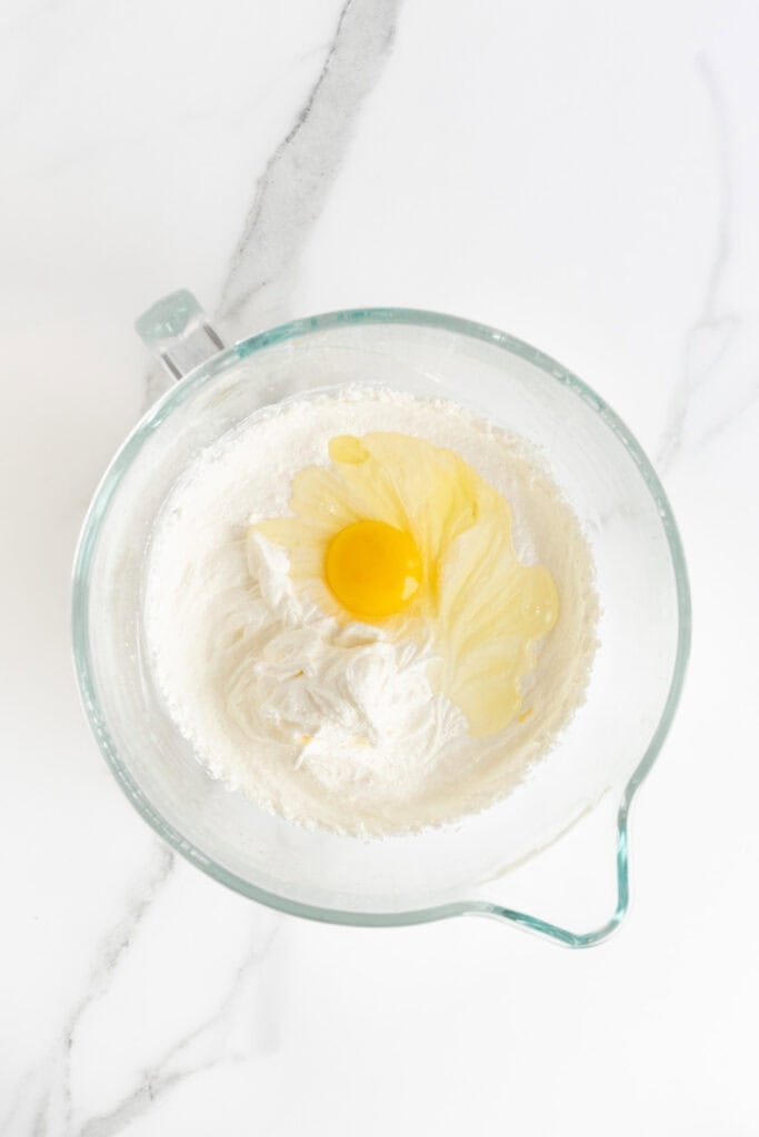 Eggs added to creamed butter, oil and sugar in stand mixer bowl