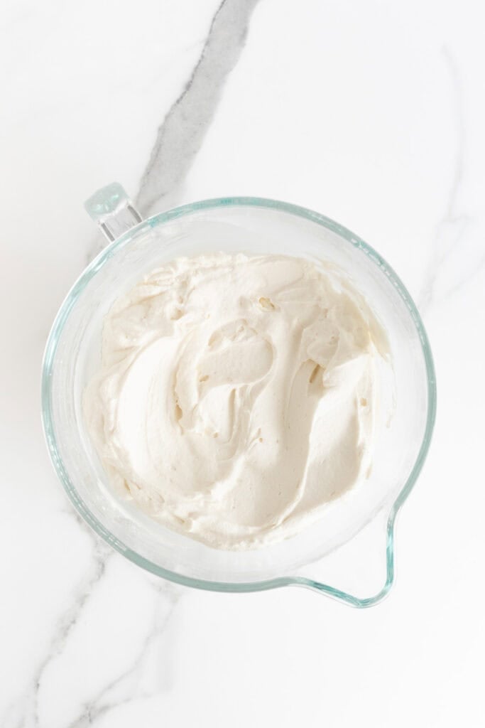 Fresh whipped cream in a mixing bowl