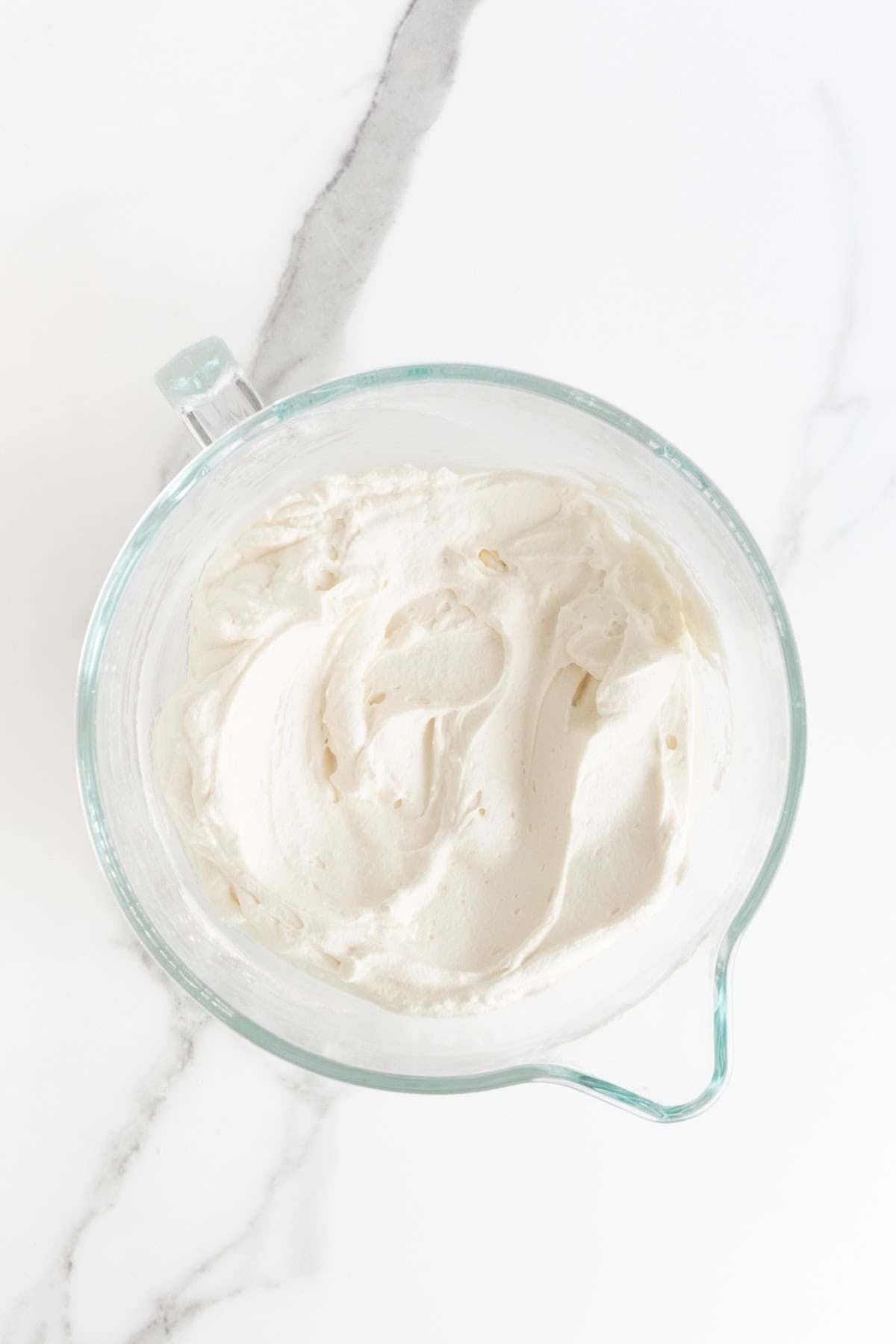Fresh whipped cream in a mixing bowl