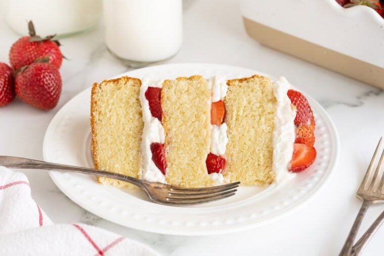 A slice of strawberry shortcake cake ready to enjoy