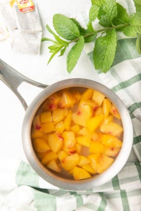 Sauteed peaches in sugar to create a simple syrup