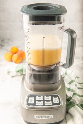 Peaches and syrup in a blender ready to add to tea