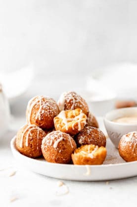 A close up of pumpkin flavored doughnut holes ready to serve