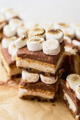 Stacks of ice cream s'more bars on parchment paper ready to serve