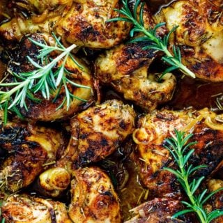 A close up of baked chicken legs and wings after coming out of the oven