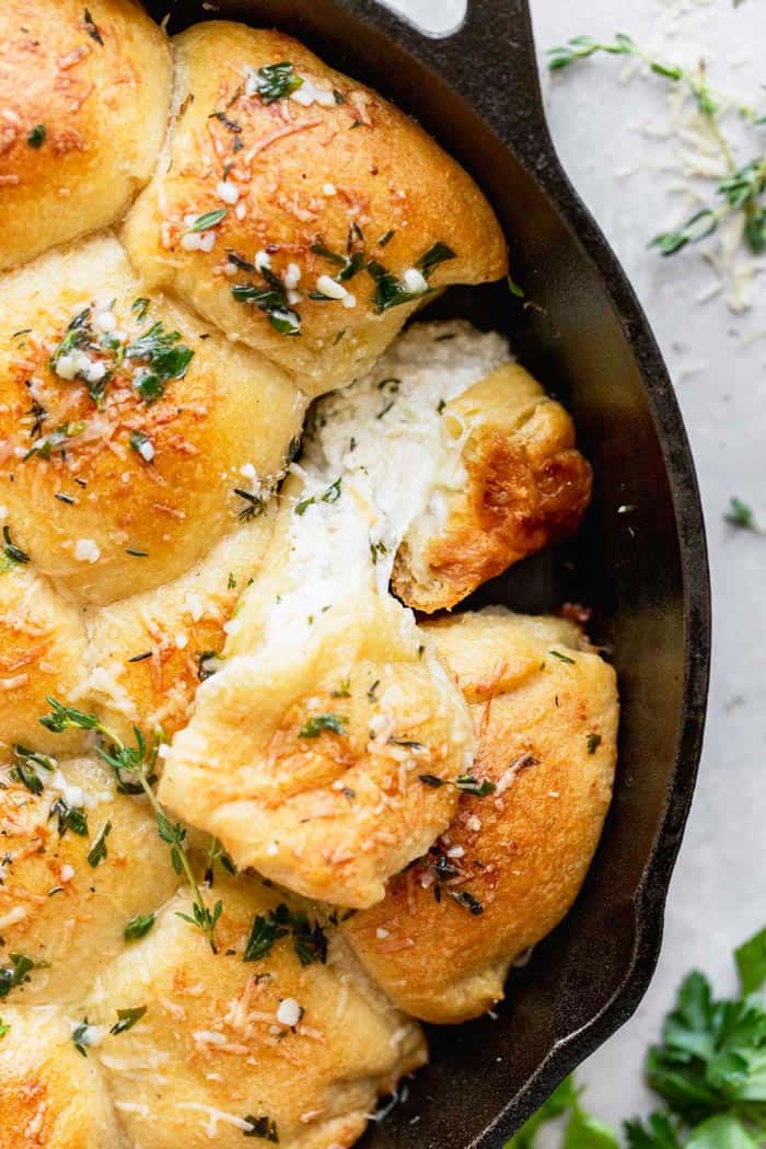 A close up of cheese rolls with one pulling cheese out