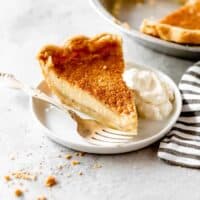 A close up of a slice of egg pie on a white plate ready to eat