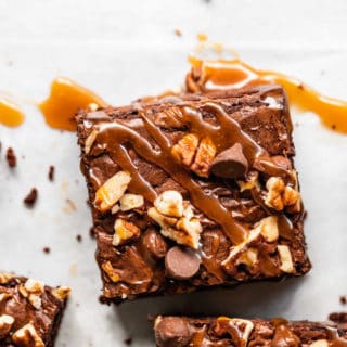 A close up of a turtle brownies with caramel drizzled on