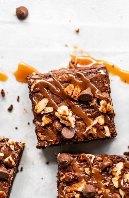 A close up of a turtle brownies with caramel drizzled on