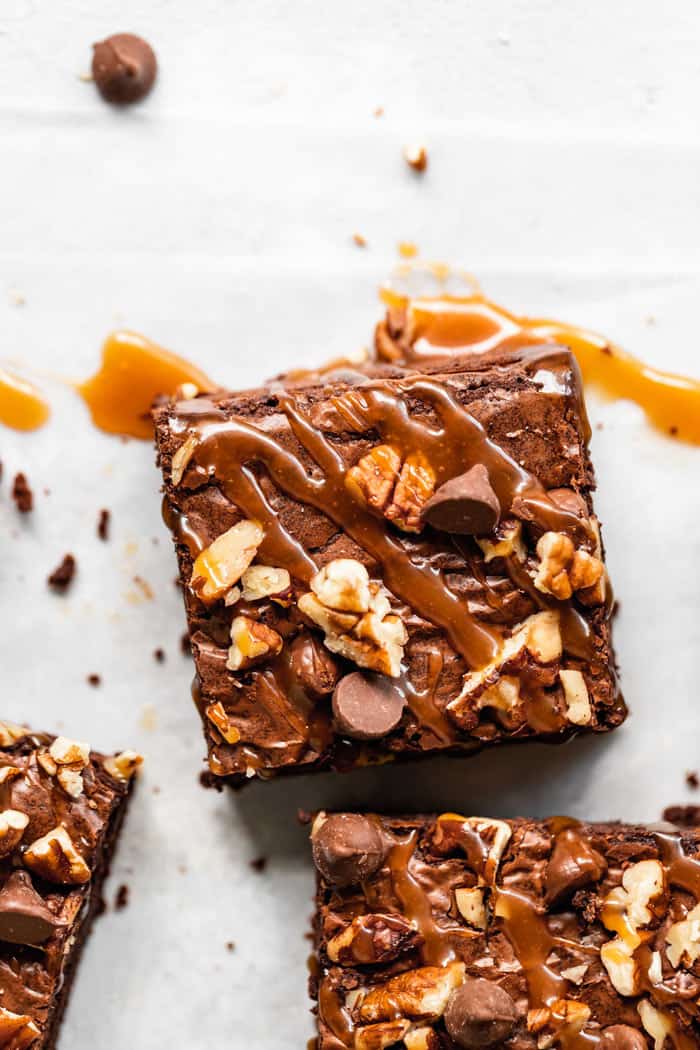 A close up of a turtle brownies with caramel drizzled on