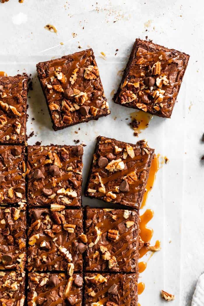 Brownies cut and being broken apart to serve