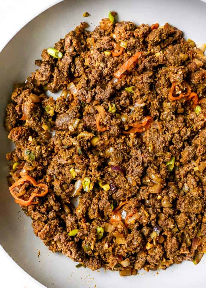 Curry beef filling in skillet ready to stuff in patties