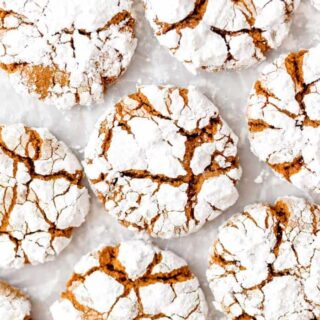 Gingerbread cookies on a white background with powdered sugar on top