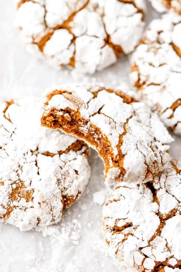 gingerbread crinkle cookies stacked on top of each with one biten