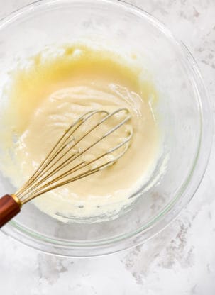 Custard being stirred with a whisk