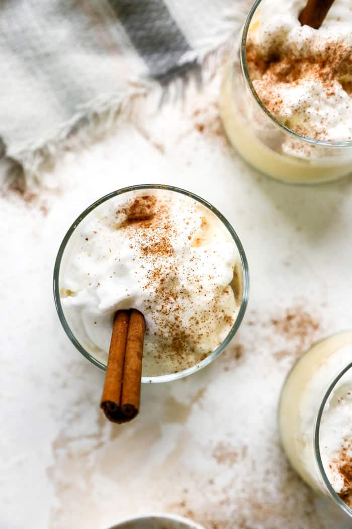 An eggnog glass filled with meringue and topped with cinnamon