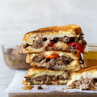 Stacks of Italian beef stuffed grilled cheese sandwiches ready to eat