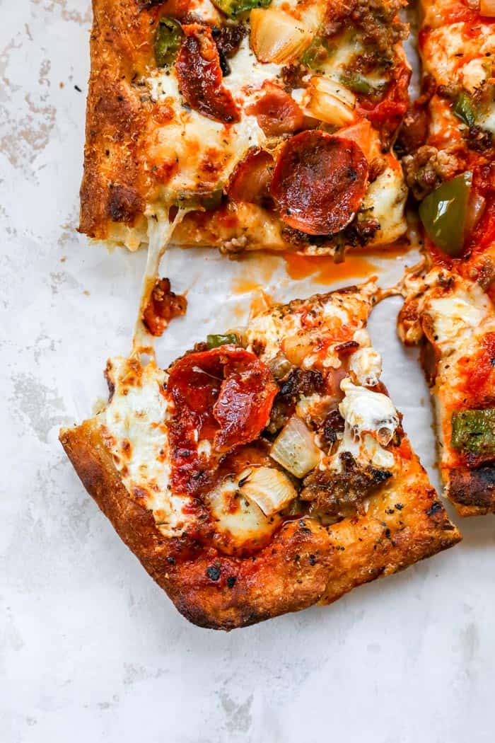 A close up overhead shot of a pizza slice ready to serve