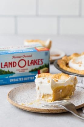 An eaten caramel pie slice next to Land O Lakes butter product