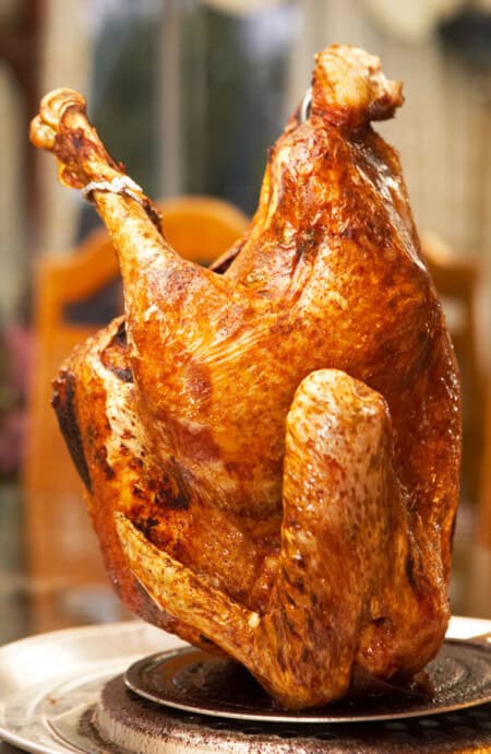 A fried turkey taken out of the oil resting before it is served
