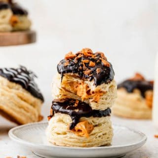 Two stuffed donuts with pumpkin cream filling with bites