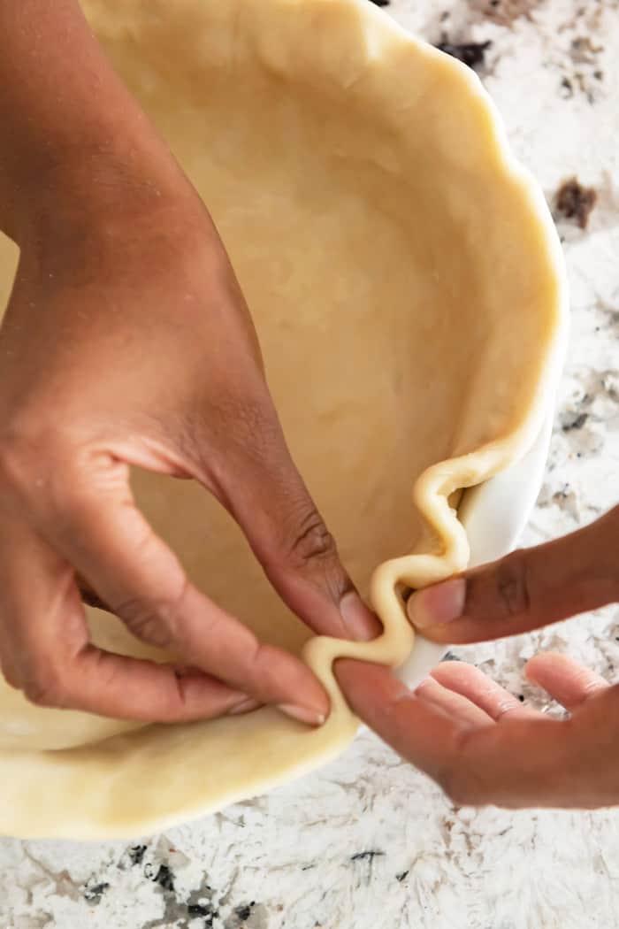 Jocelyn Delk Adams crimping a pie dough for a pecan pie recipe