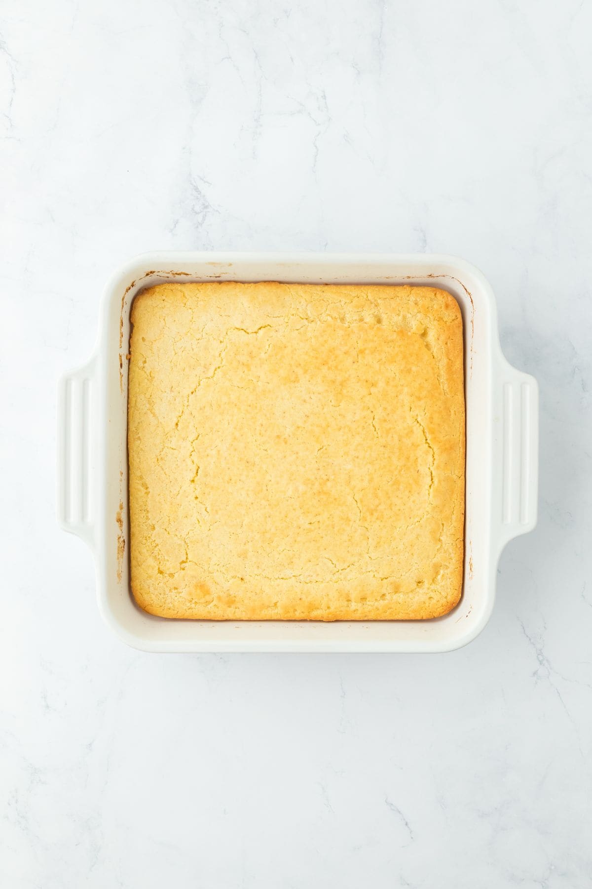 Golden-baked cornbread in a white rectangular dish